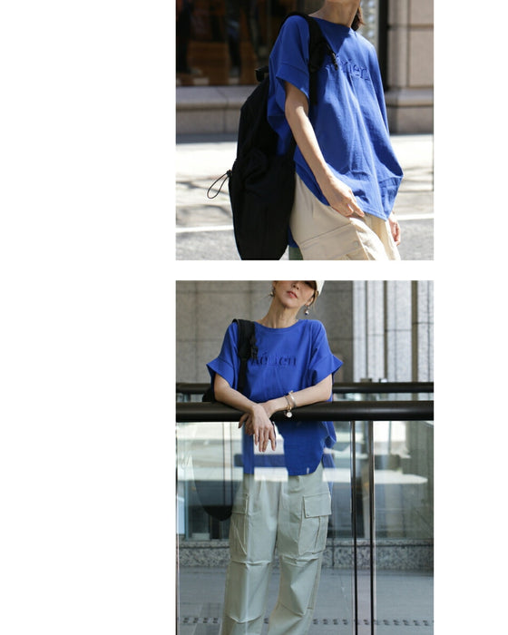 A logo T-shirt with sharp horn sleeves and tucked hem for a sophisticated look