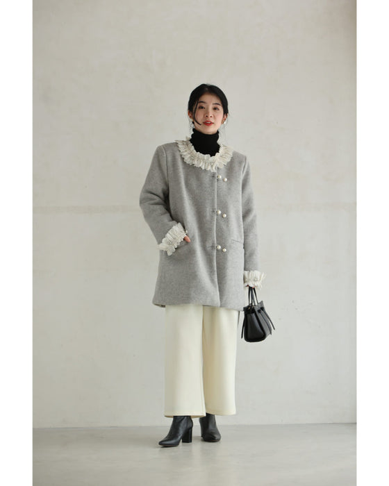 A pearl button coat with sparkling beaded daisy frills