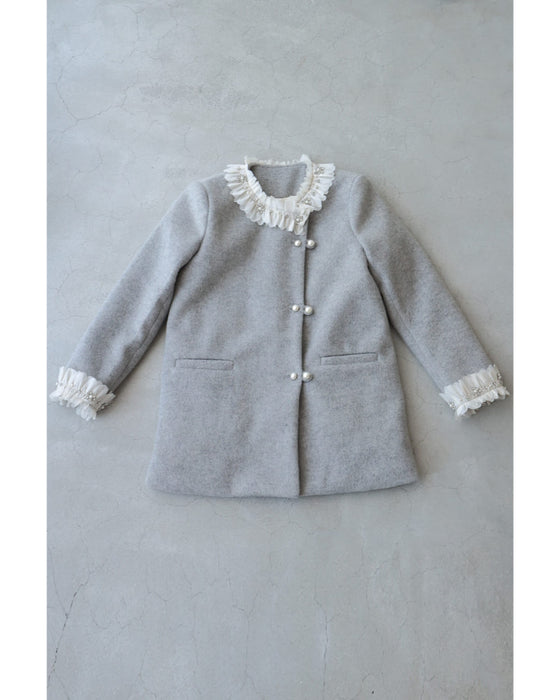 A pearl button coat with sparkling beaded daisy frills
