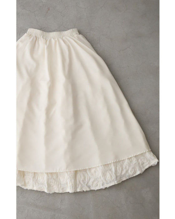 A voluminous bouquet skirt wrapped in rose flowers