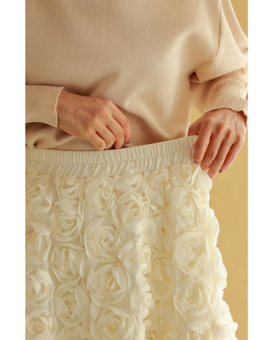A voluminous bouquet skirt wrapped in rose flowers