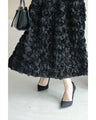 A voluminous bouquet skirt wrapped in rose flowers