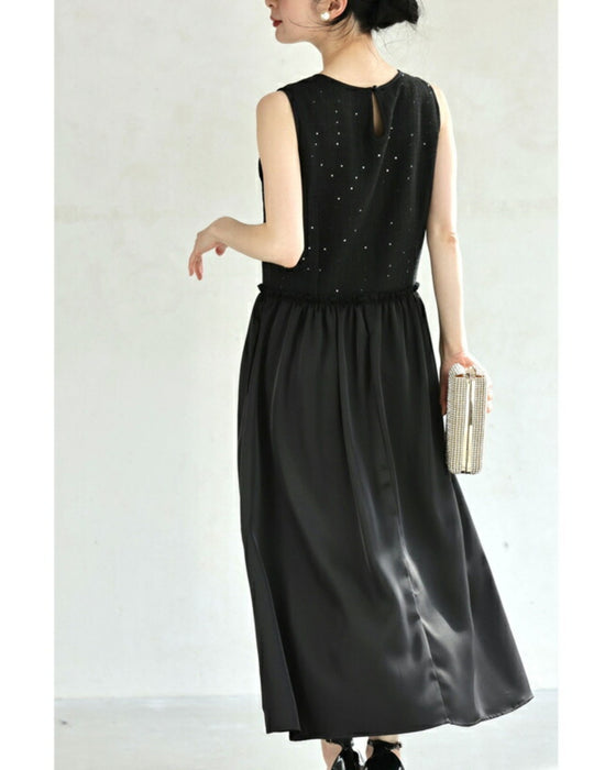 A dress with a tweed-like top and a glossy skirt, sparkling with sequins