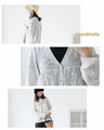 A thin cardigan with delicate floral embroidery
