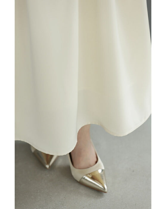 A dress with a tweed-like top and a glossy skirt, sparkling with sequins