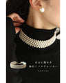 A luxurious, shiny piece for your neck. Wide pearl choker