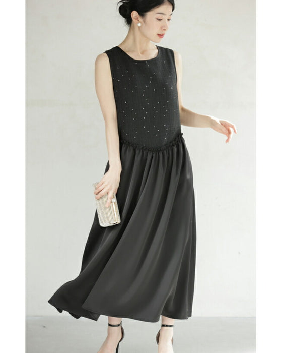 A dress with a tweed-like top and a glossy skirt, sparkling with sequins