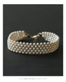 A luxurious, shiny piece for your neck. Wide pearl choker
