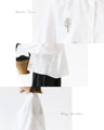 A blouse with pale colors and embroidered Nordic trees