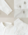 A blouse with pale colors and embroidered Nordic trees