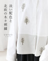 A blouse with pale colors and embroidered Nordic trees