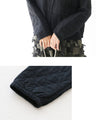 A quilted asymmetrical top that can be worn over the head