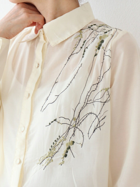 A loose shirt top with a hint of wood