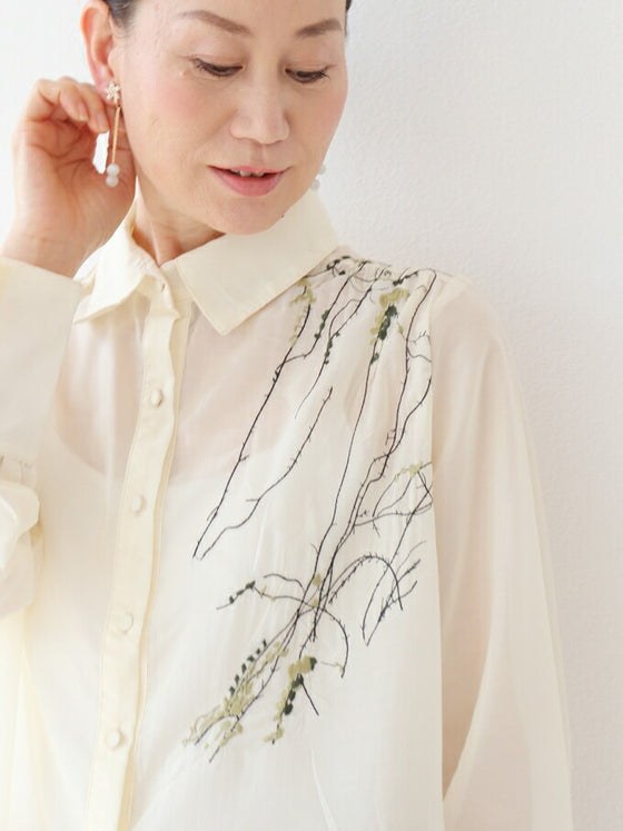 A loose shirt top with a hint of wood