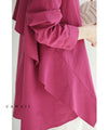 A collared shirt top with ruffles flowing from the back