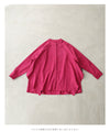 A collared shirt top with ruffles flowing from the back