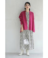 A collared shirt top with ruffles flowing from the back