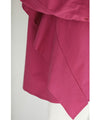 A collared shirt top with ruffles flowing from the back