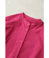 A collared shirt top with ruffles flowing from the back