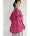 A collared shirt top with ruffles flowing from the back