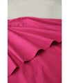 A collared shirt top with ruffles flowing from the back