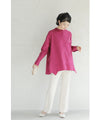 A collared shirt top with ruffles flowing from the back