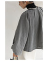 A short outerwear with puffy sleeves
