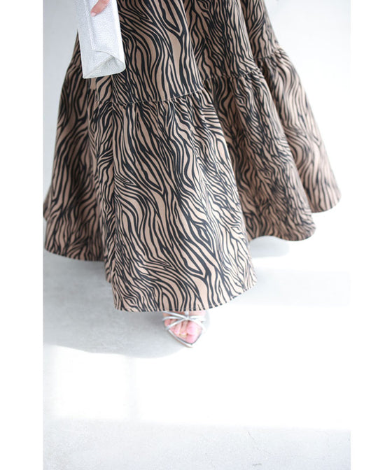 A long skirt with a fluttering animal print art style