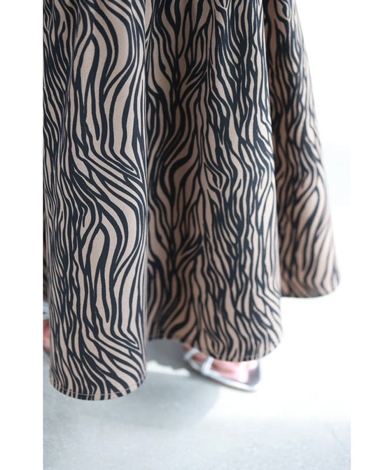 A long skirt with a fluttering animal print art style