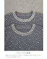 A bell-sleeve knit top with pearls falling all over it