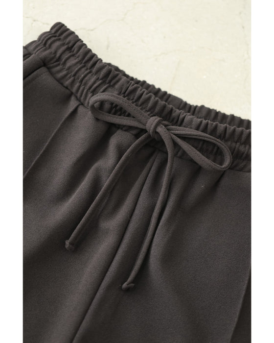 チュールの花が裾に咲くウエストゴムテーパードパンツ