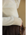 A fluffy knit top with finely sparkling sequins and fluffy collar and sleeves