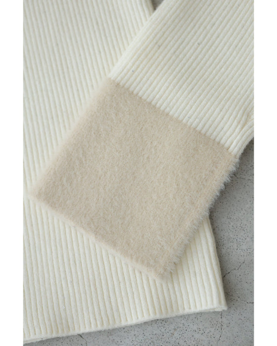 A fluffy knit top with finely sparkling sequins and fluffy collar and sleeves