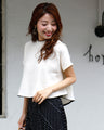 Goes great with skirts! A short, flared top that makes your legs look longer just by wearing it.