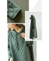 A quilted-style parka dress with distinctive stitching lines