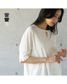 A sophisticated adult top with tucked sleeves