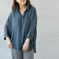 A loose dolman blouse for adults in dull blue