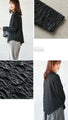 A unique black top with ruffled shirring and irregular hem