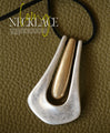 A large motif suede string long necklace that looks great on a daily basis