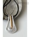 A large motif suede string long necklace that looks great on a daily basis