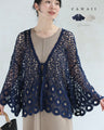 A teardrop-shaped knit lace cardigan with a flared hem