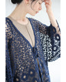 A teardrop-shaped knit lace cardigan with a flared hem