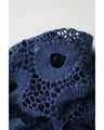 A teardrop-shaped knit lace cardigan with a flared hem