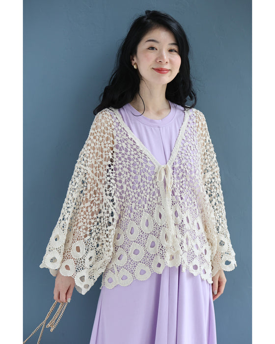 A teardrop-shaped knit lace cardigan with a flared hem