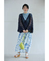 A teardrop-shaped knit lace cardigan with a flared hem