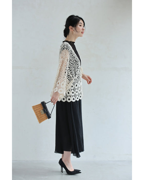 A teardrop-shaped knit lace cardigan with a flared hem