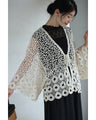 A teardrop-shaped knit lace cardigan with a flared hem
