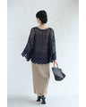 A teardrop-shaped knit lace cardigan with a flared hem