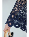 A teardrop-shaped knit lace cardigan with a flared hem