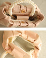 Glossy pearl-handled mini bag with strap